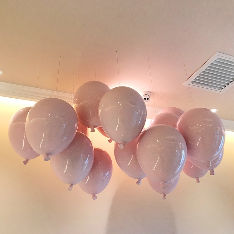 Hanging fiberglass balloons for retail store window display