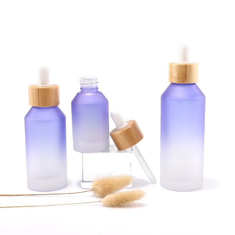 Glass bottle with bamboo dropper for cosmetic packaging