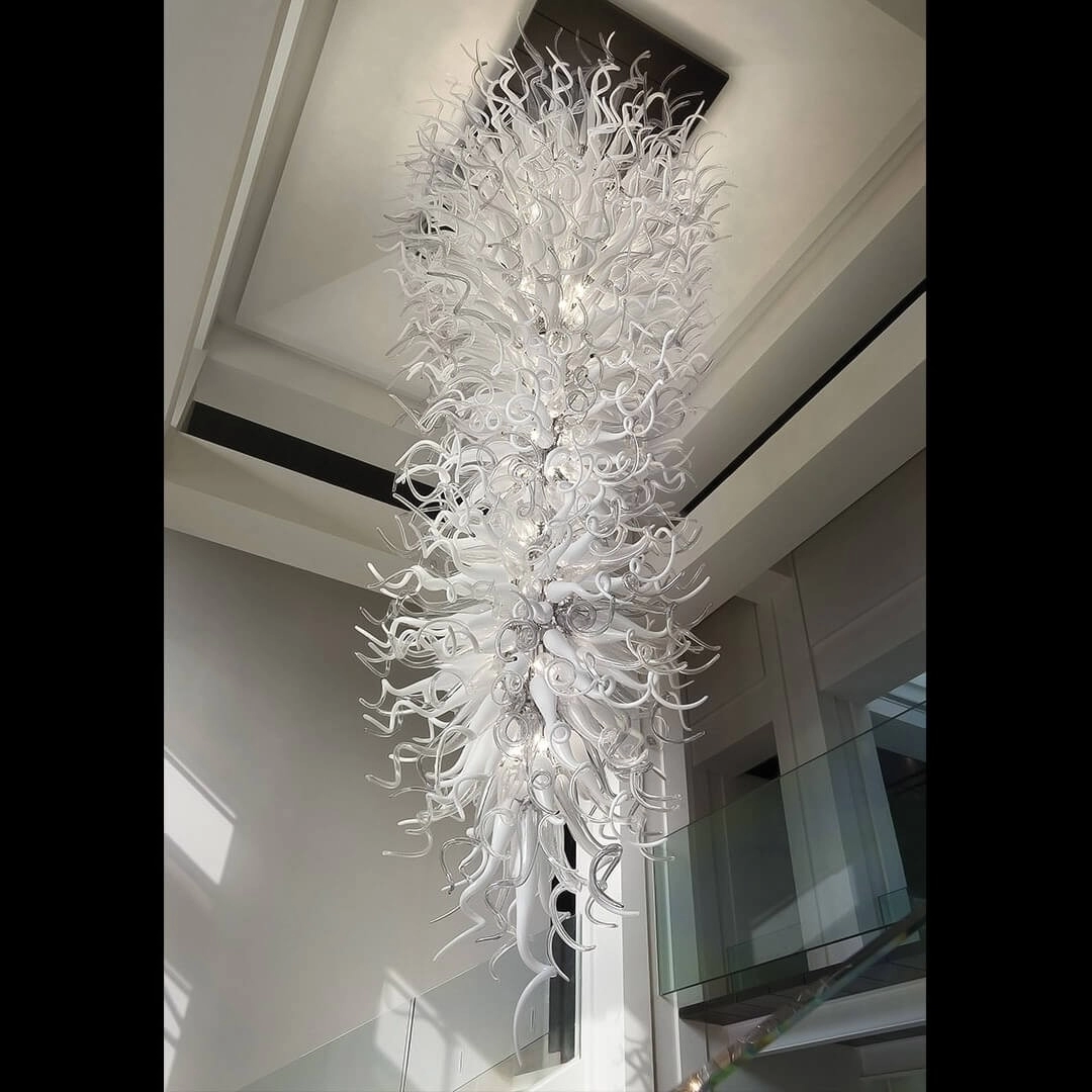 White chihuly style chandelier for long stairwell